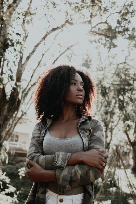 Mulher negra de cabelo crespo, corte na altura dos ombros