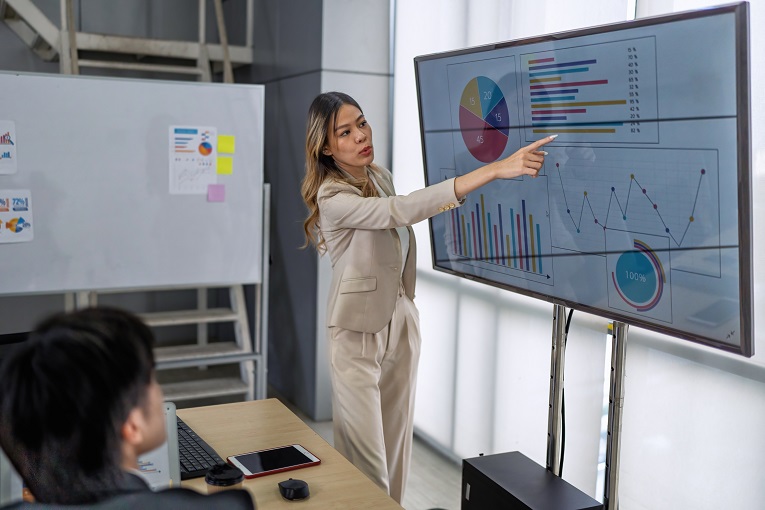 Mulher em uma reunião de negócios, fazendo uma apresentação em slides